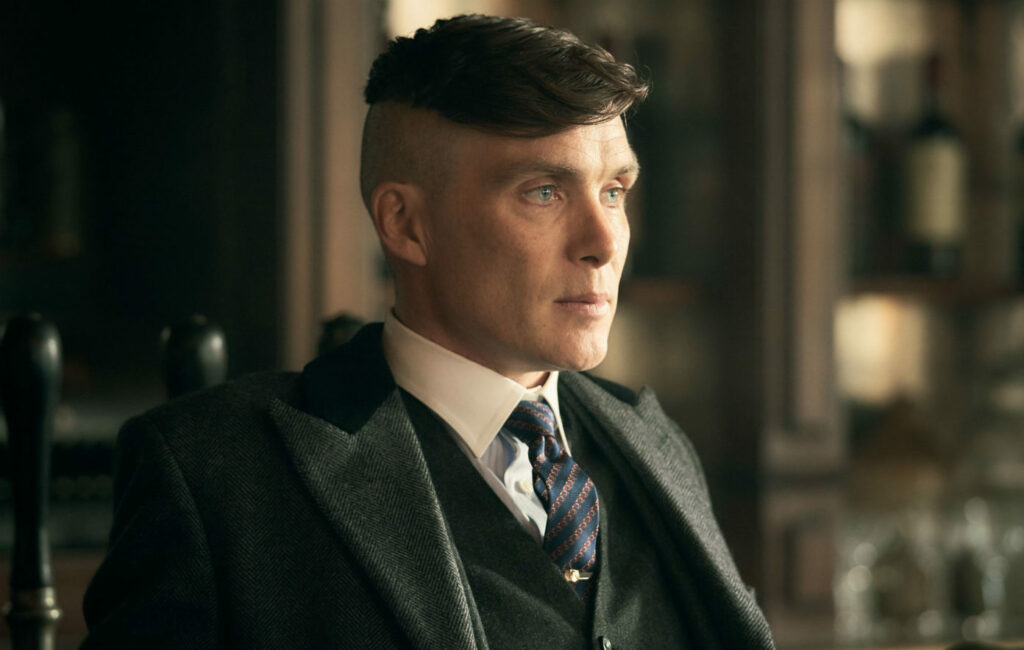 Cillian Murphy as Tommy Shelby looks off camera in Peaky Blinders