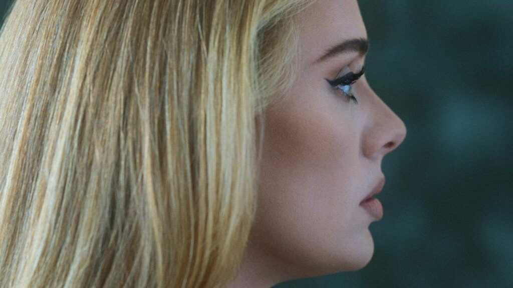 Photo of Adele's profile with a blurry green background