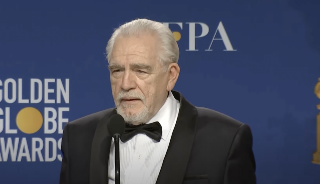 Brian Cox poses in front of a blue background at the Golden Globe Awards