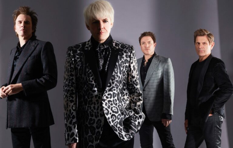 Duran Duran pose on a grey background