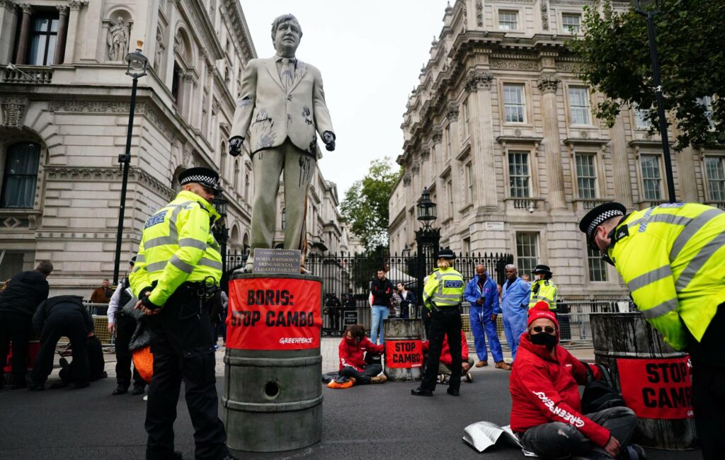 Greenpeace campaigners protest outside Downing Street