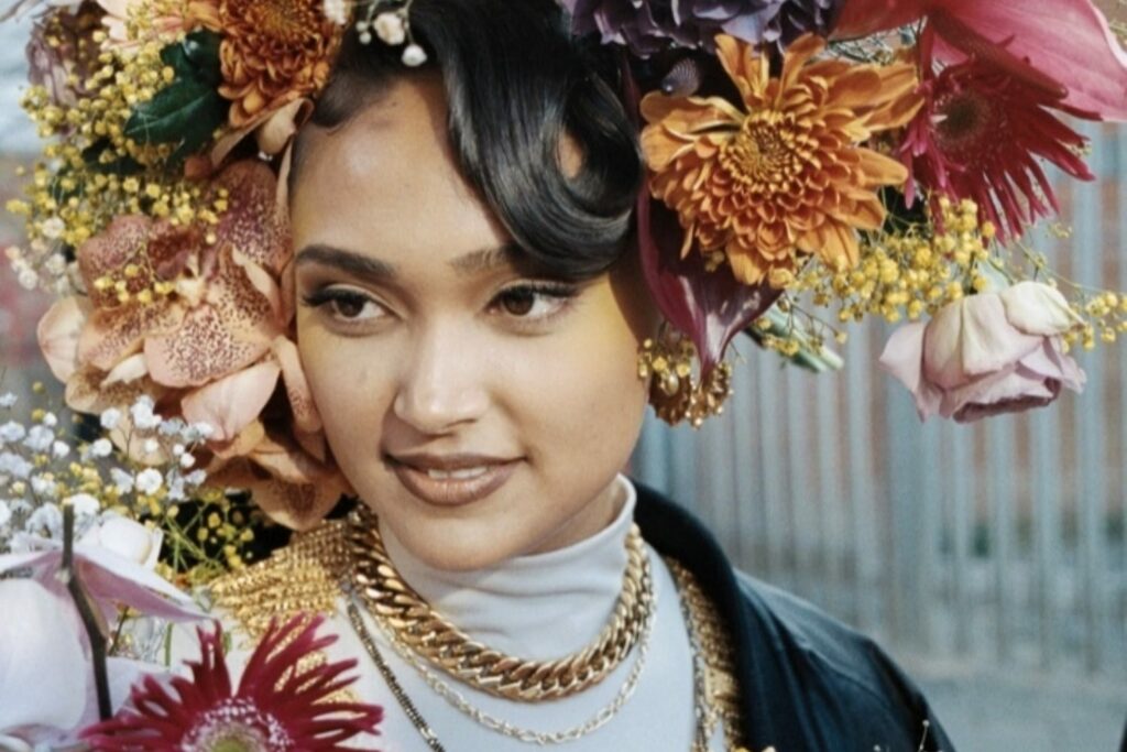 Joy Crookes is decked in flowers for the When You Were Mine video