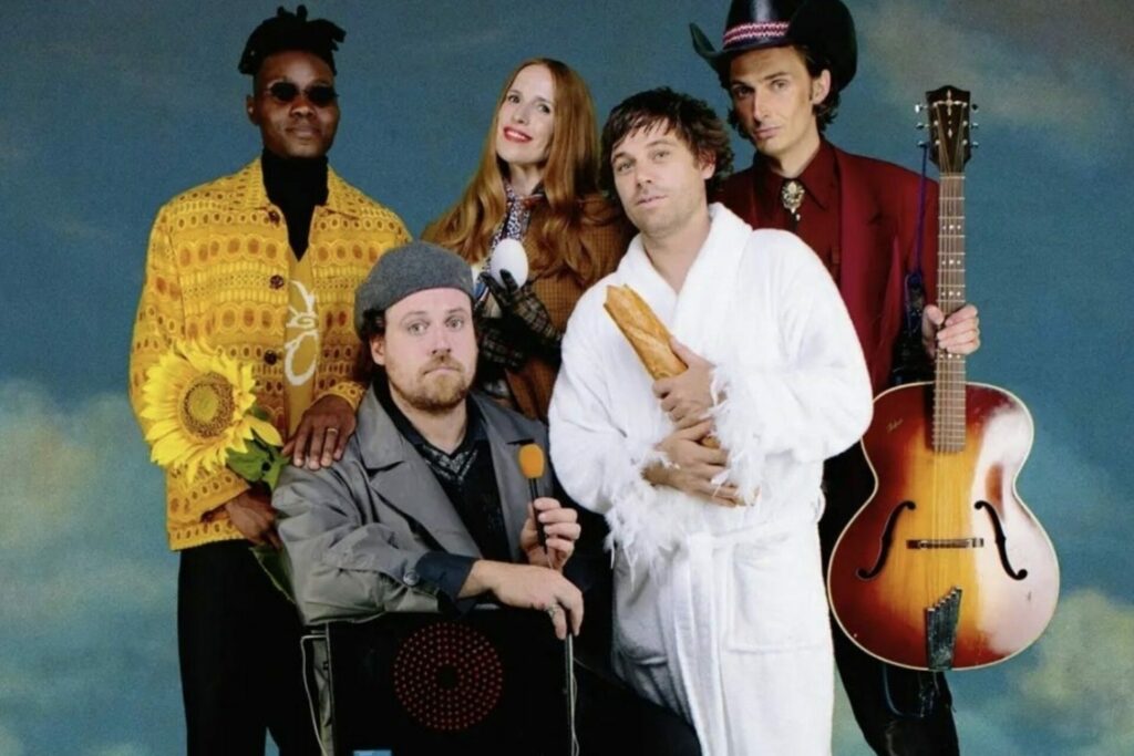 Metronomy press photo featuring the members of the and wearing colourful clothes for their music video