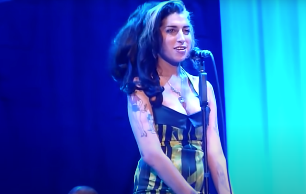 Amy Winehouse wears a halter neck mini dress in her last performance