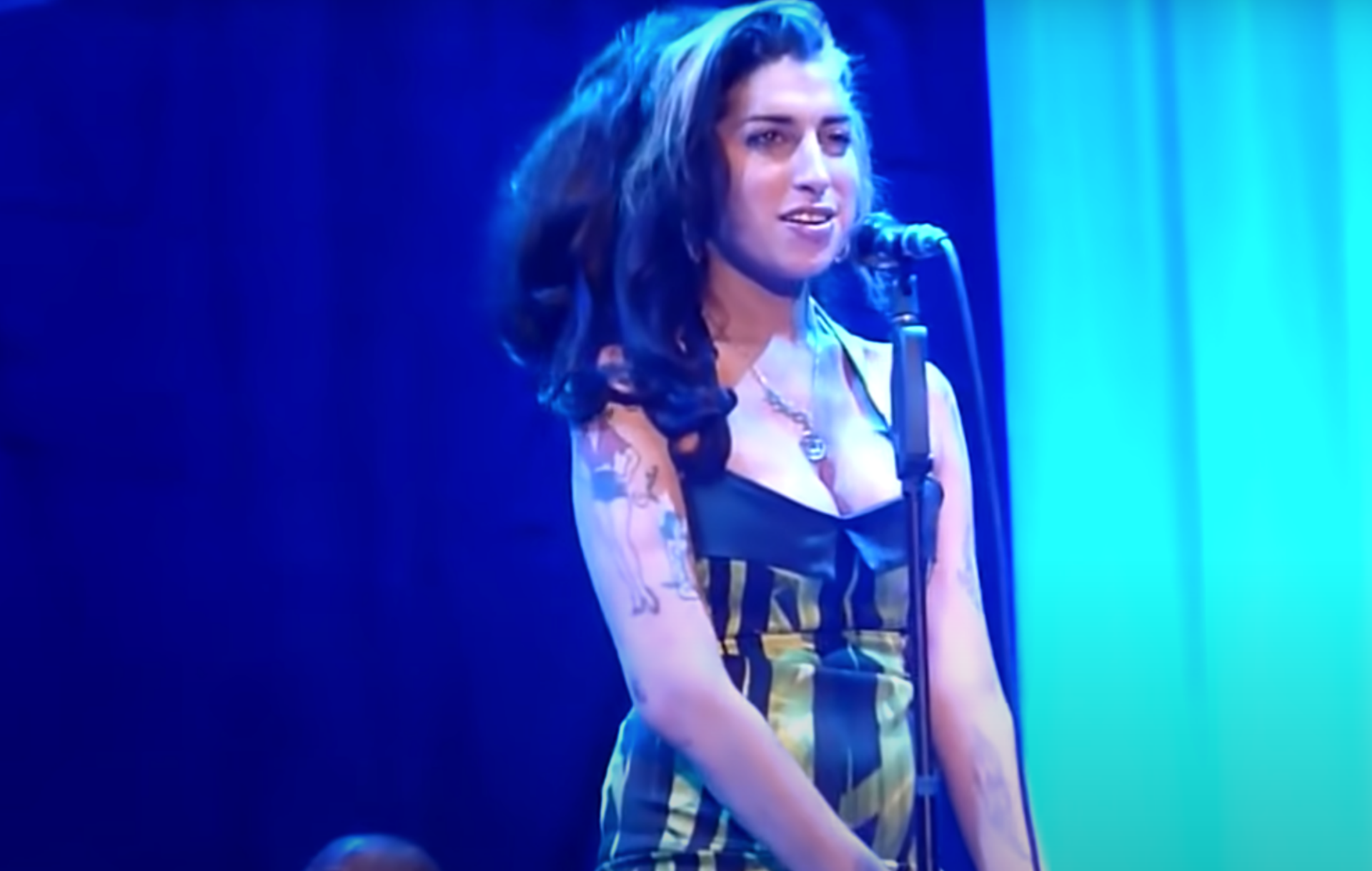 Amy Winehouse wears a halter neck mini dress in her last performance