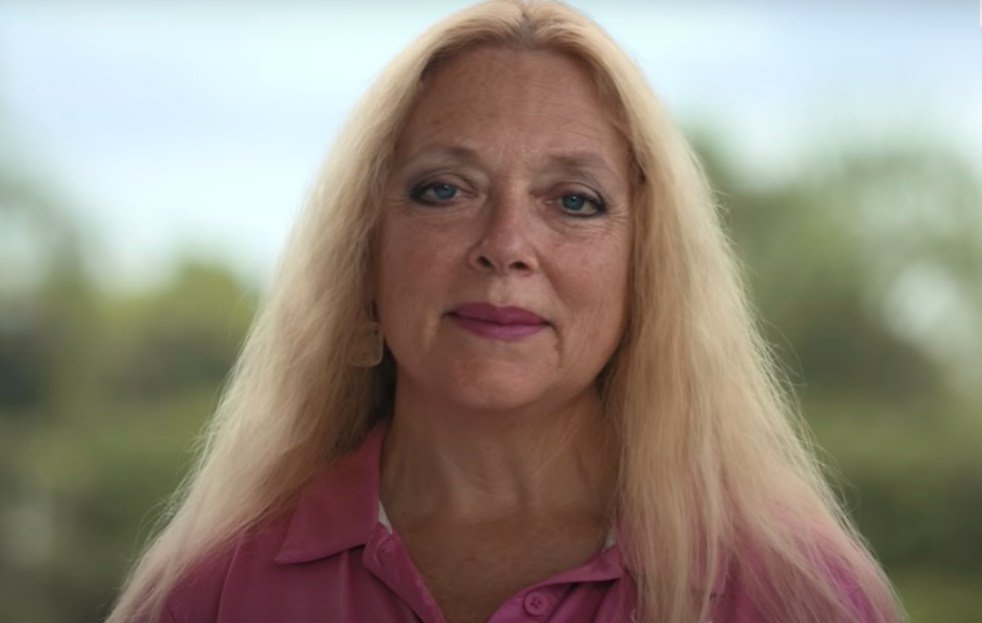 Carole Baskin wears a pink shirt and faces the camera in the trailer for 'Tiger King 2'