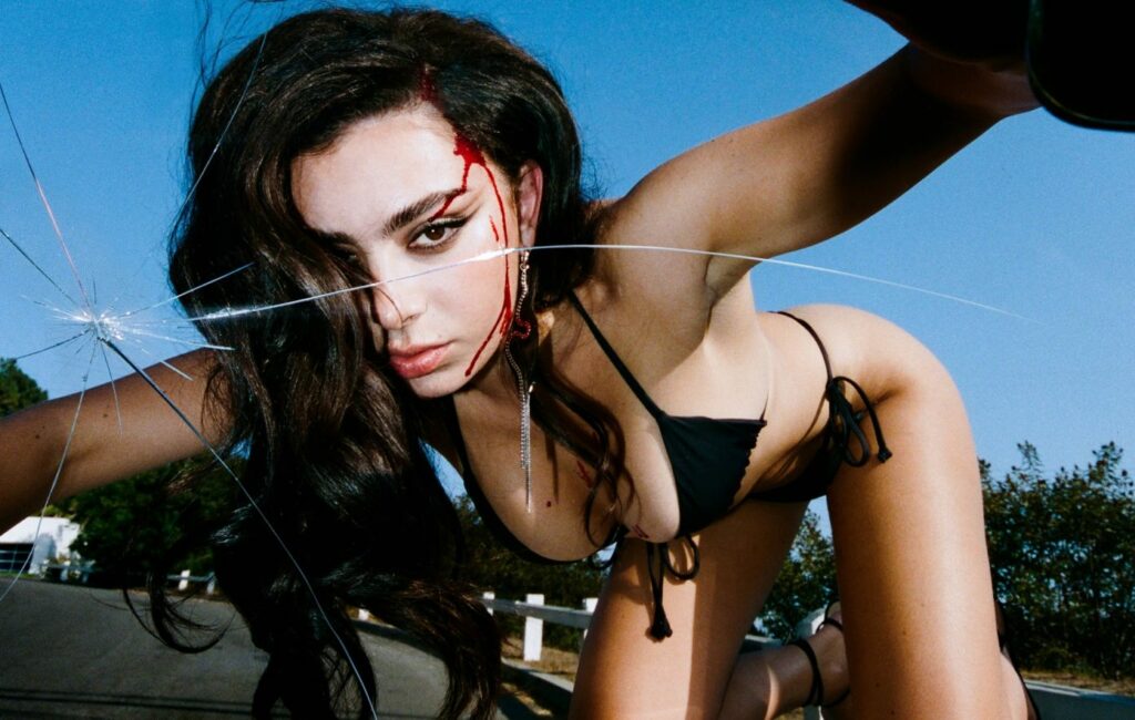Charli XCX wears a bikini with blood dripping down her head in a press shot