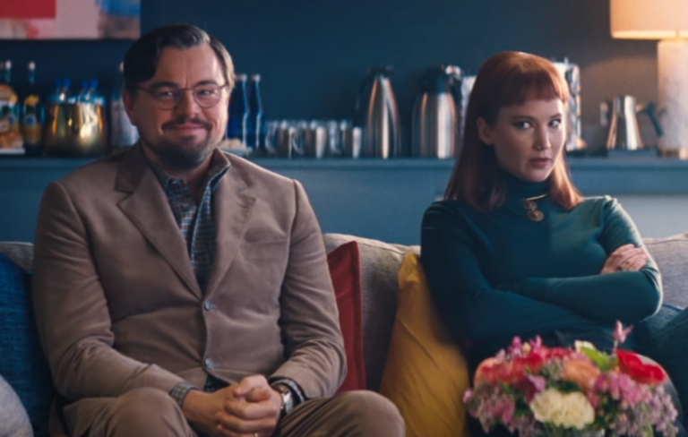 Leonardo DiCaprio and Jennifer Lawrence sit on a couch in the trailer for 'Don't Look Up'