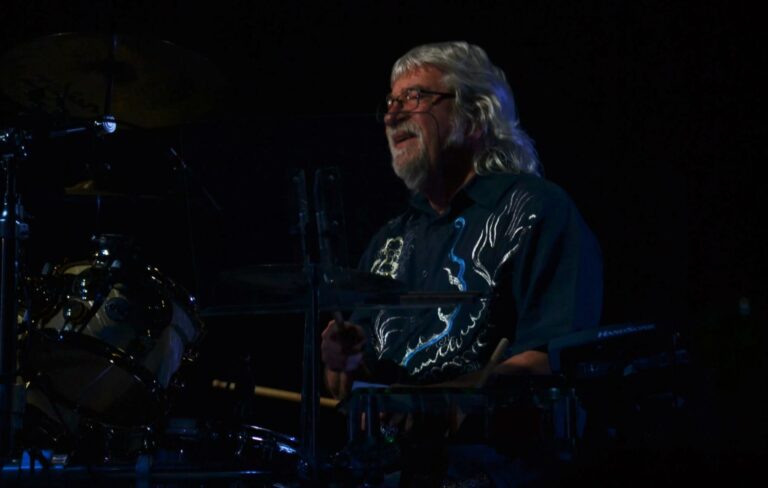 Graeme Edge pictured sat behind a drumkit