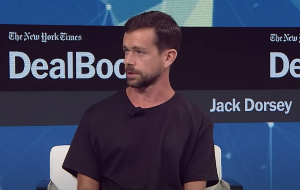 Jack Dorsey wears a black t-shirt on stage during a live talk