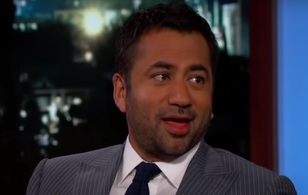 A still of Kal Penn in a suit on the Jimmy Kimmel Show).
