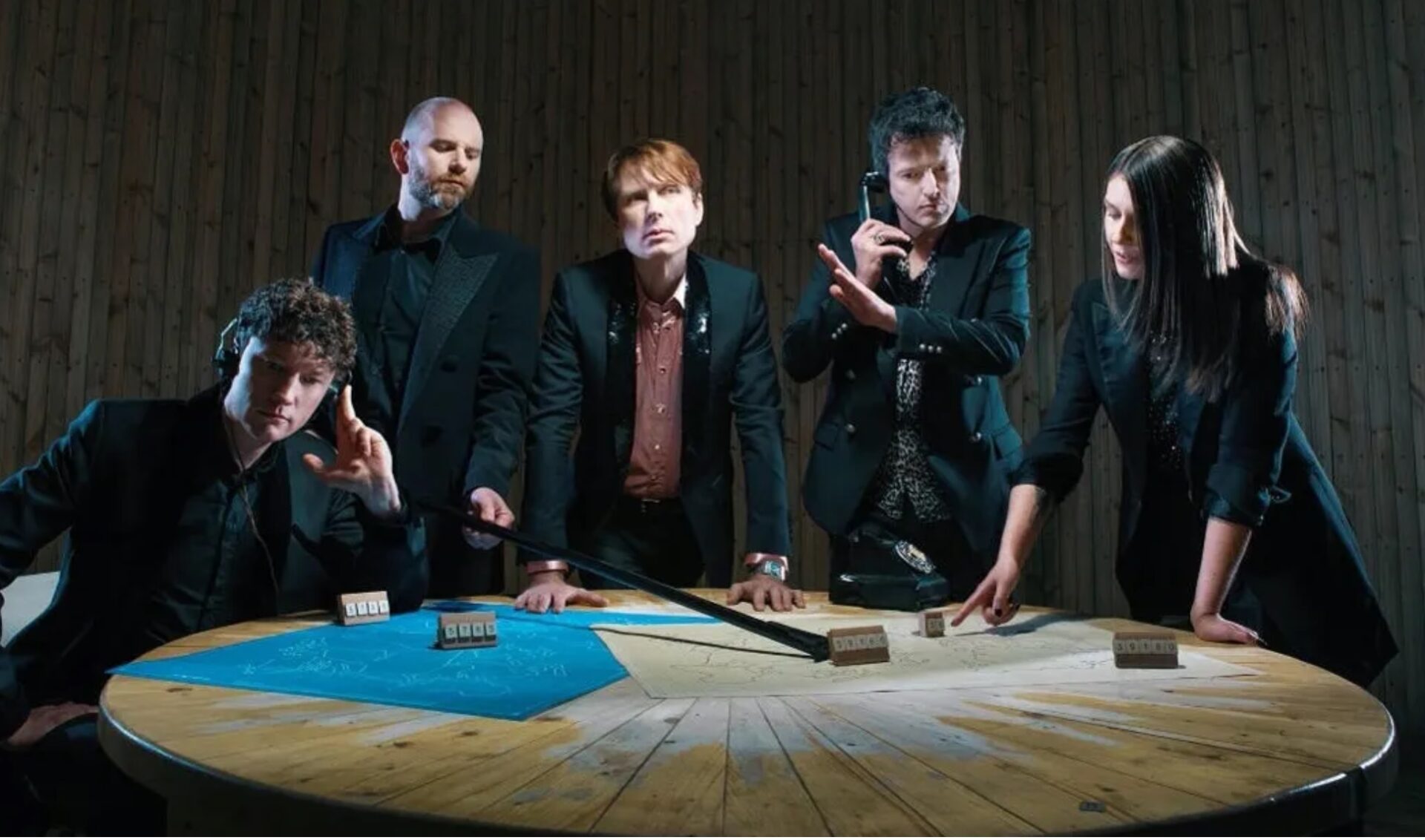 Franz Ferdinand in a darkened room in front of a table