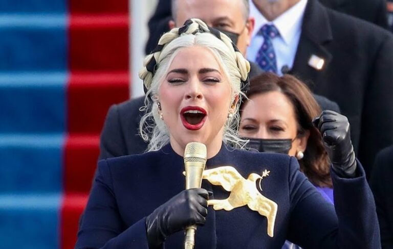 Lady Gaga singing into a gold microphone at the US Capitol building