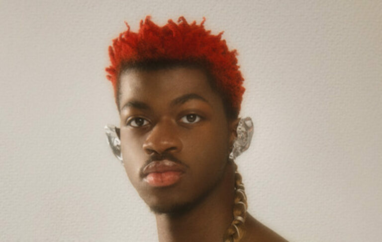 Lil Nas X looking directly at the camera with red hair