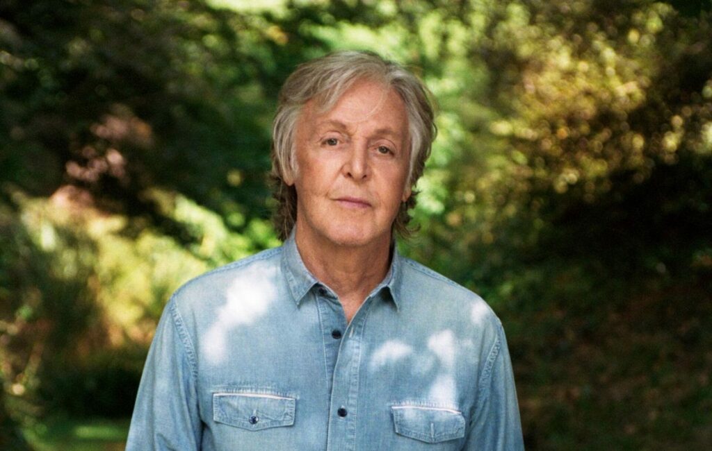 Paul McCartney standing in a garden