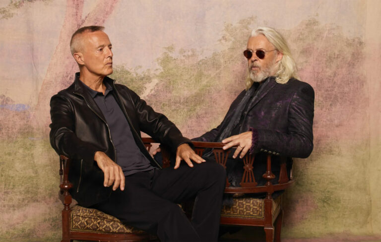 Roland Orzabal and Curt Smith sit facing one another in two chairs