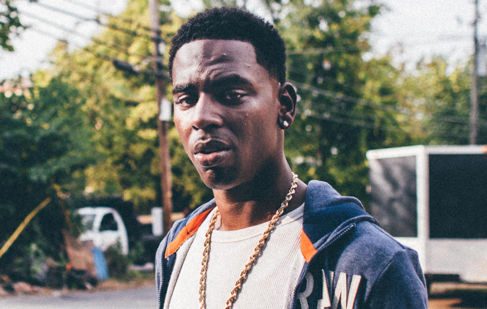 Young Dolph poses outside