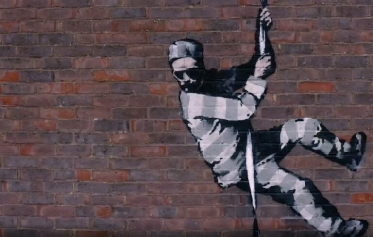 Banksy's stencil of a prisoner escaping on the side of Reading Gaol