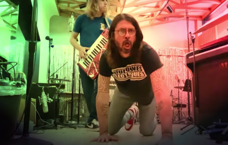 Dave Grohl crawls on the floor and Greg Kurstin plays the keyboard
