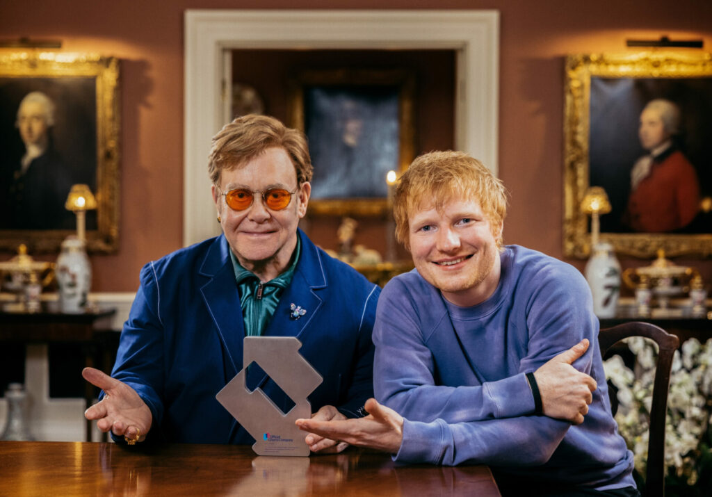 Ed Sheeran and Elton John with their award for 'Merry Christmas'.