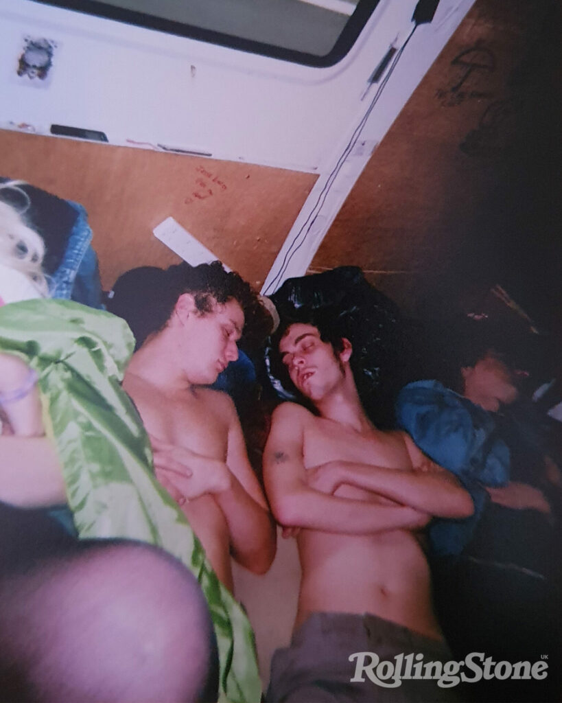 Joe and Saul of Fat White Family sleep topless next to each other in the back of the van