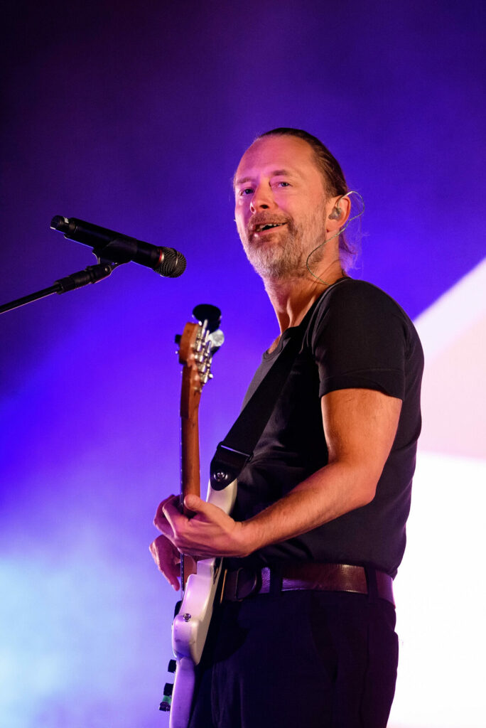 Radiohead's Thom Yorke performs live in Bilbao, Spain, holding a guitar against a purple background