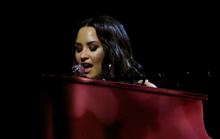 Demi Lovato is seen performing on a piano in 2018