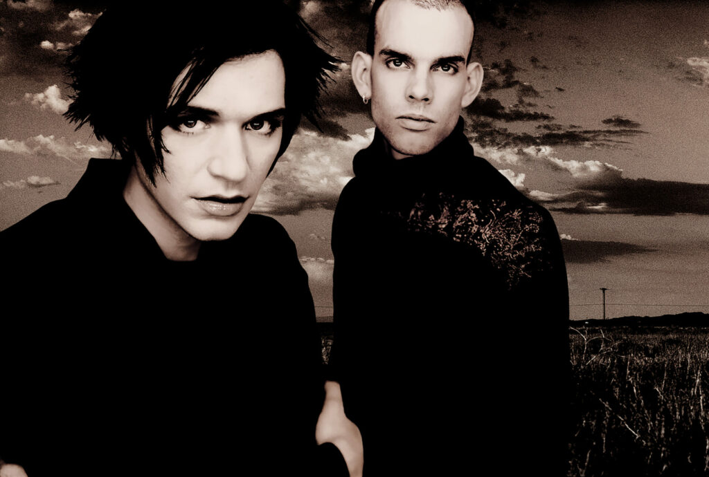 Brian Molko and Stefan Olsdal of Placebo pose in a sepia photo
