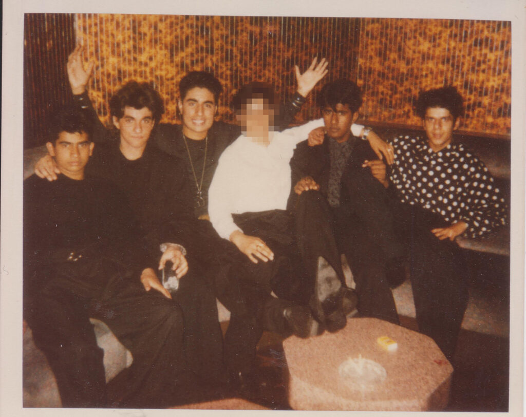 A group of South Asian friends smile at a music event