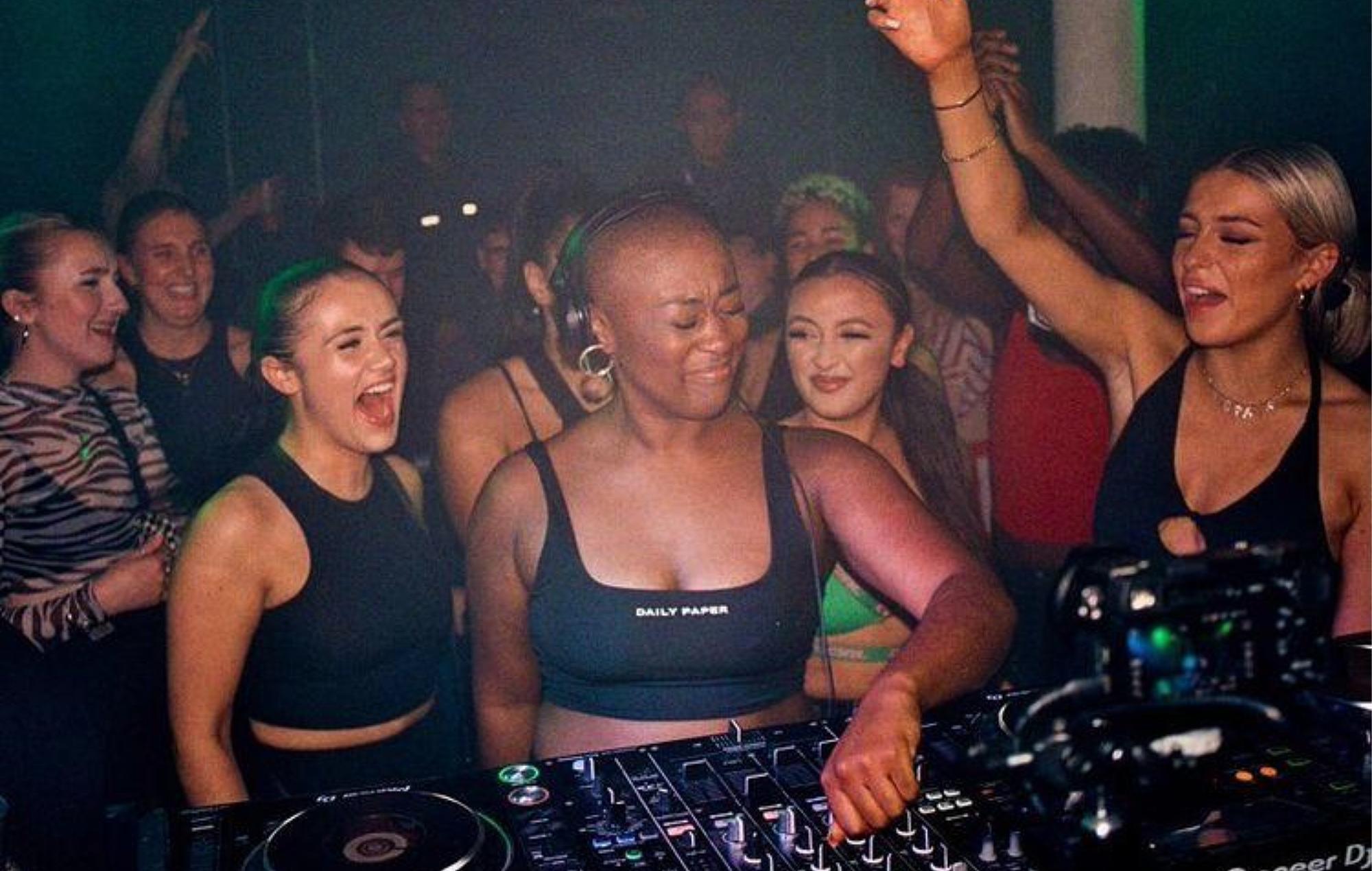 People dance to a DJ