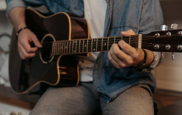 A man plays an acoustic guitar