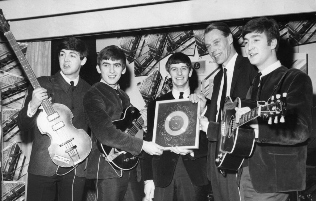 The Beatles receive a Silver Disc from George Martin of EMI