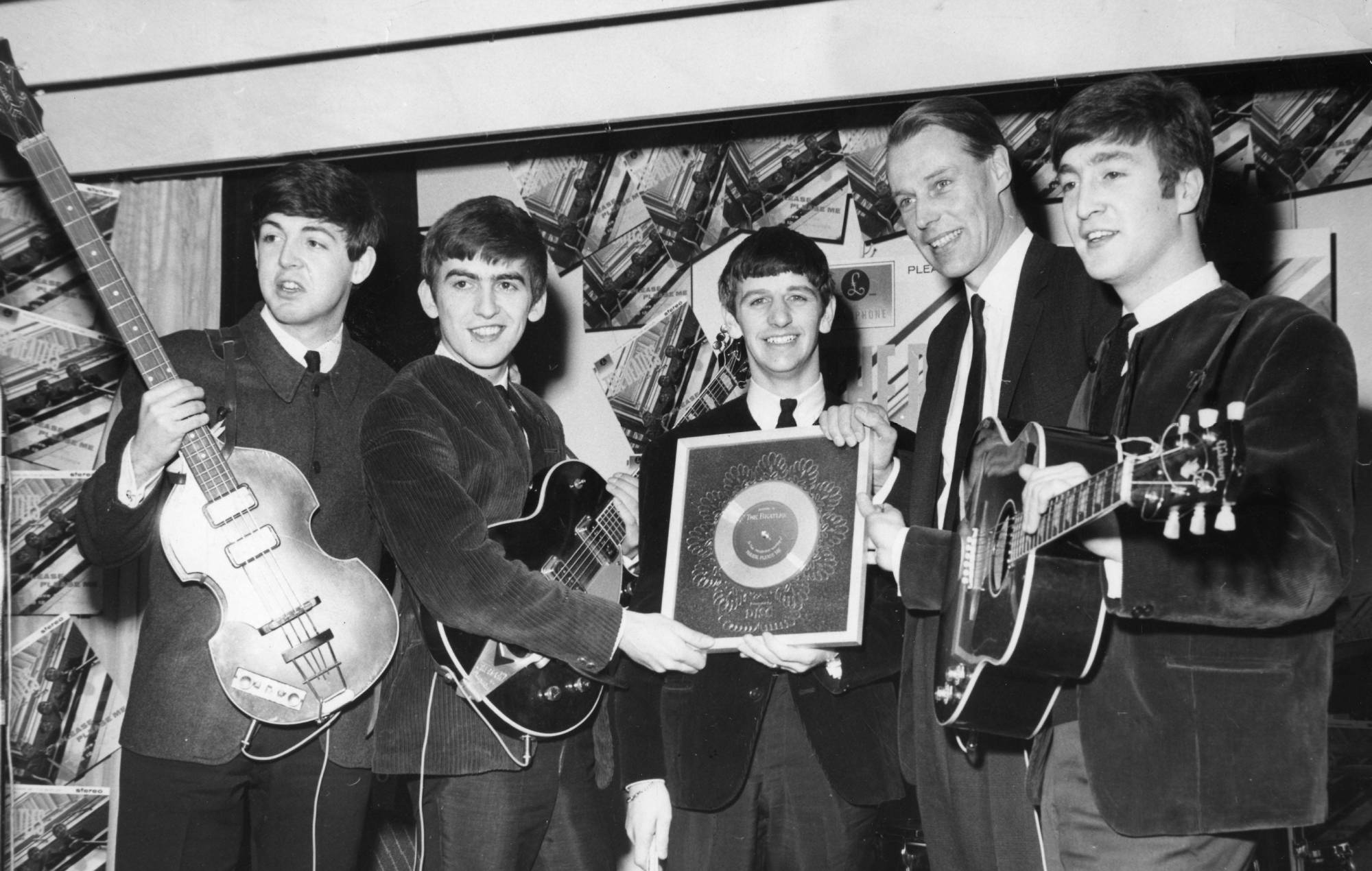 The Beatles receive a Silver Disc from George Martin of EMI