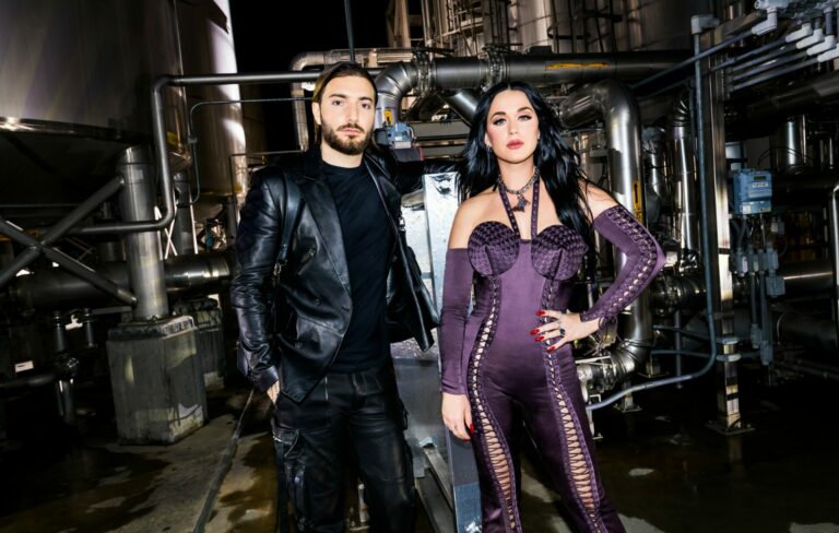 Alesso wears a black leather suit next to Katy Perry in a purple bodysuit