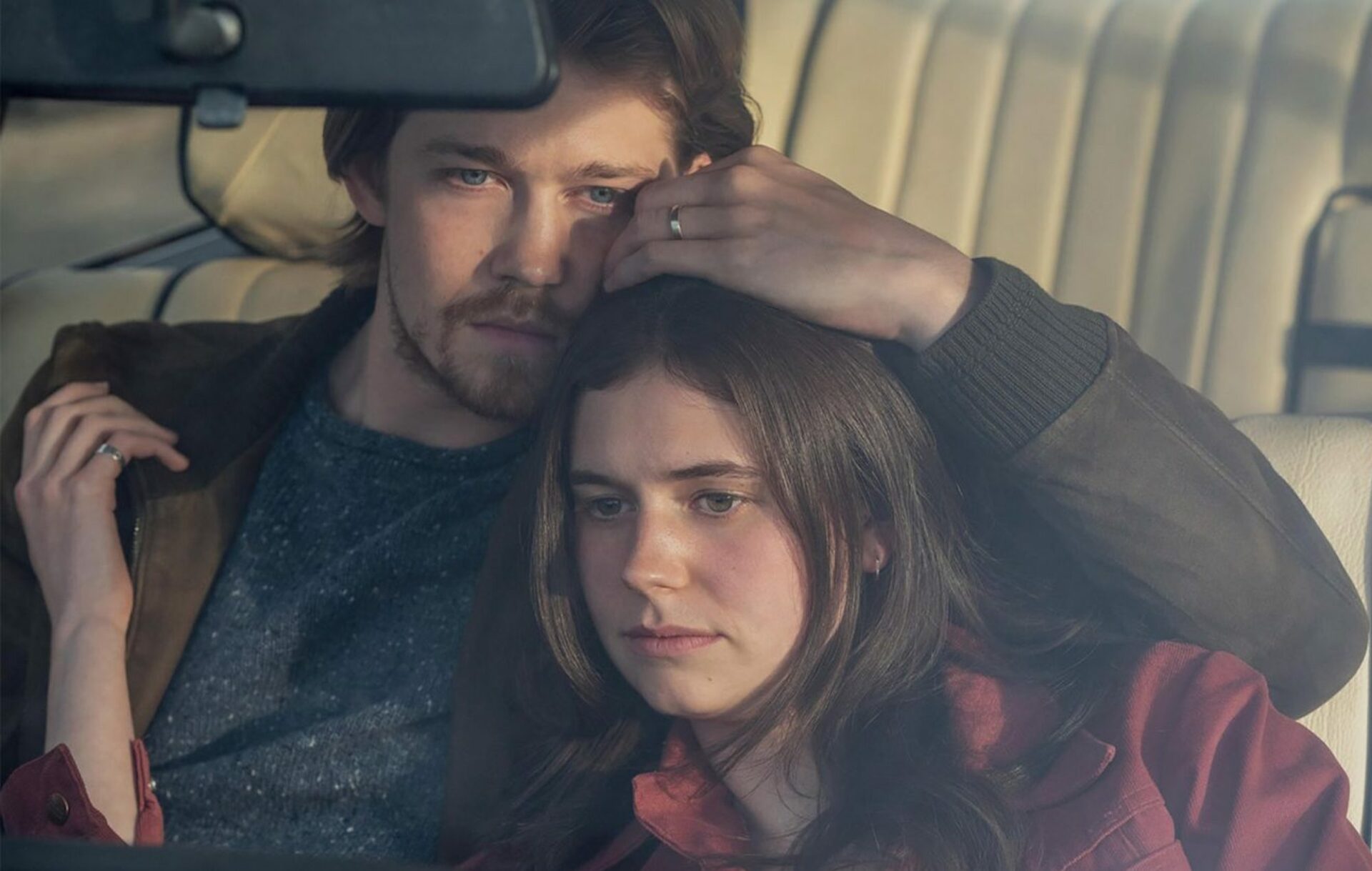 Frances lays her head on Nick's chest in a car in a scene from 'Conversations With Friends'