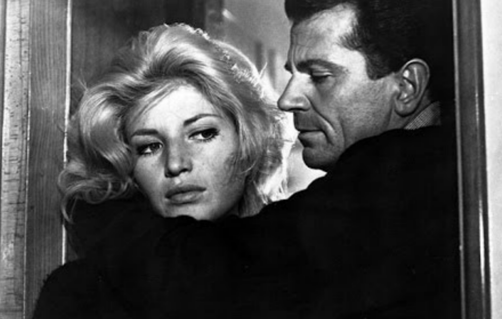 Monica Vitti looks past her co-star in a black and white still of 'L'AVVENTURA'