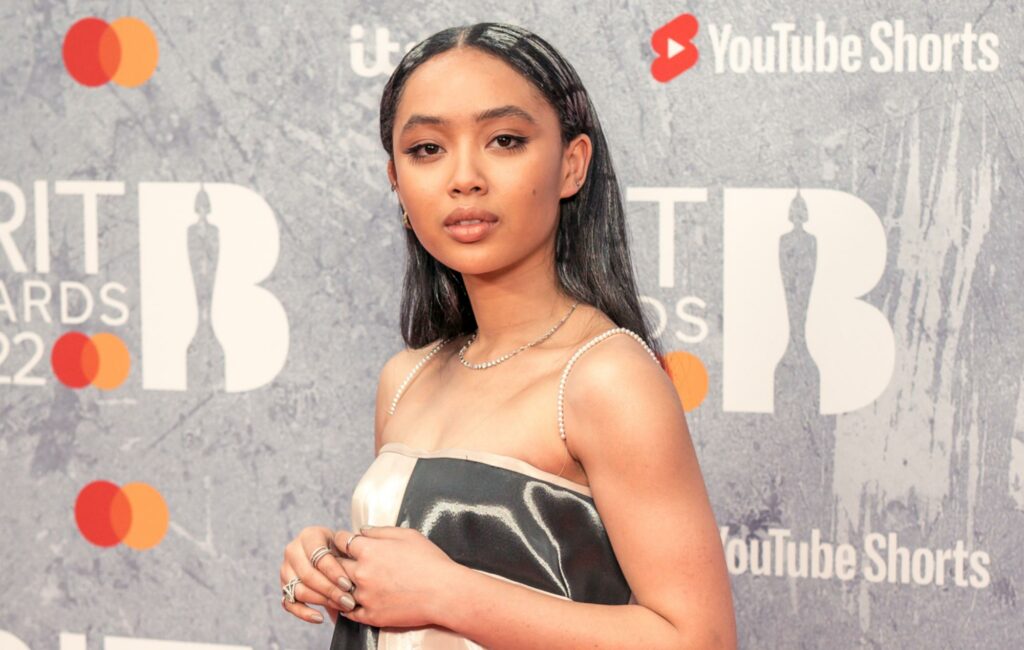Griff poses on the BRIT Awards 2022 red carpet in a black-and-white dress