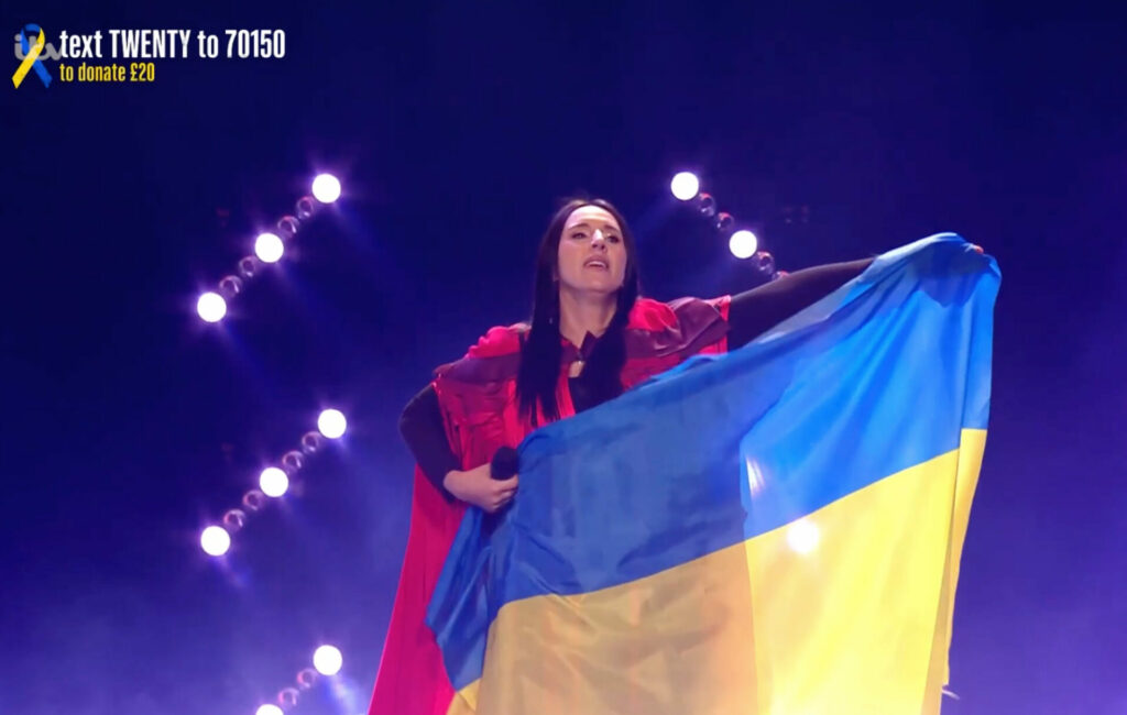 Jamala holding a Ukrainian flag aloft at ITV's 'Concert for Ukraine', March 29, 2022