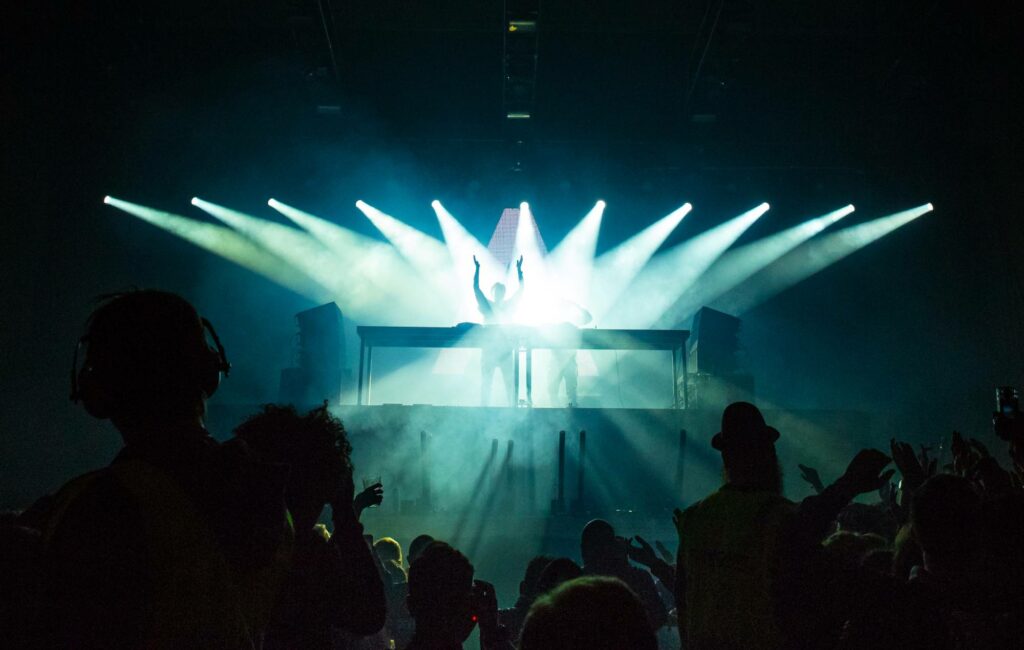 A crowd in a nightclub enjoy a DJ set