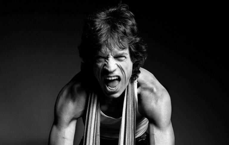 Mick Jagger stares at the camera and shouts in black-and-white press picture