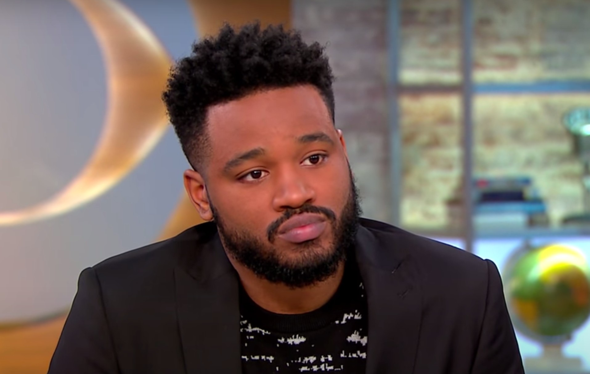 A headshot of Ryan Coogler speaking live on CBS Mornings