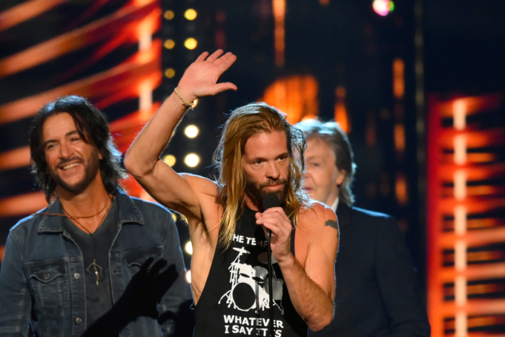 Taylor Hawkins, with Paul McCartney behind him, at the 2021 Rock and Roll Hall of Fame induction ceremony.