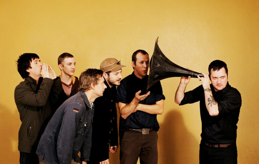 Modest Mouse and Johnny Marr posing for a press shot