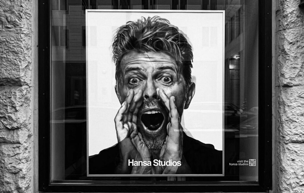 A black and white holographic picture of David Bowie at Hansa Studios yelling through his hands