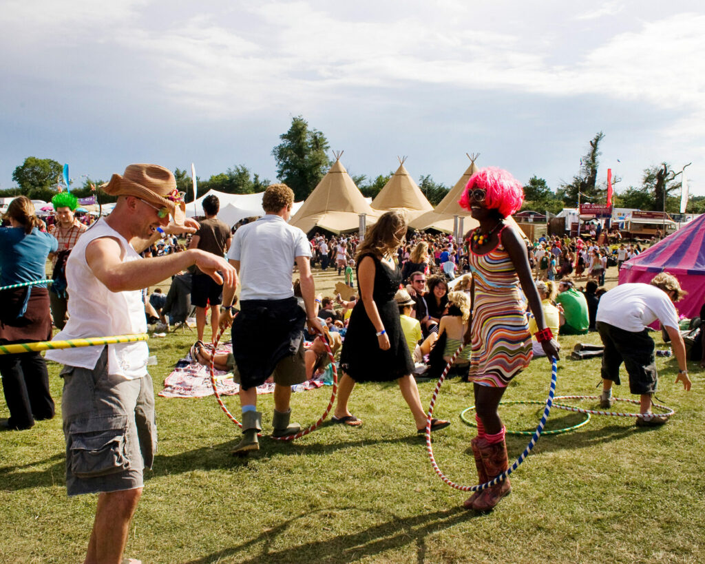 People dance with hula hoops at Secret Garden Party festival