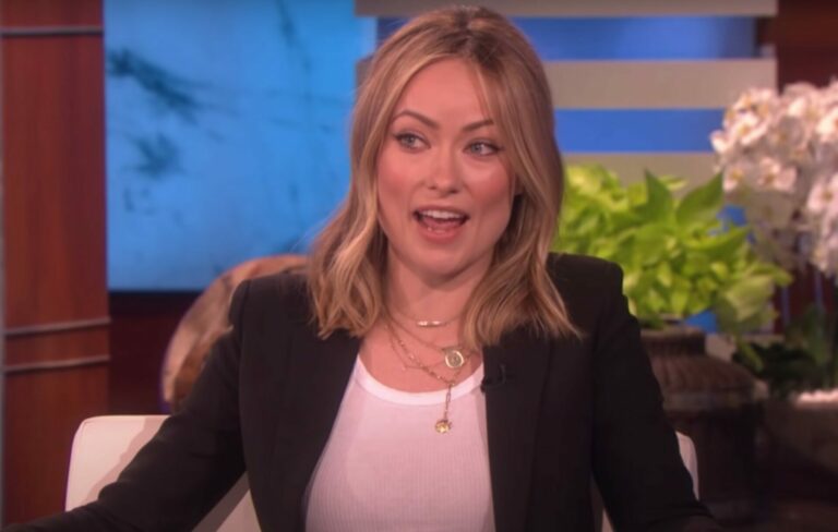 Olivia Wilde wears a white shirt and black blazer during an appearance on The Ellen Show