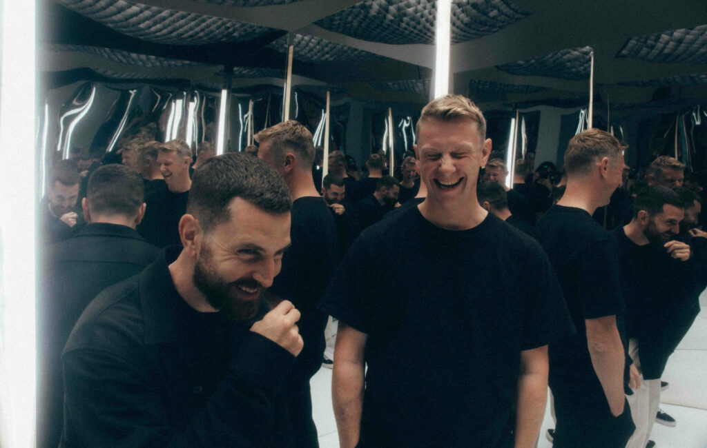 Bicep posing in a room of mirrors for a press photo