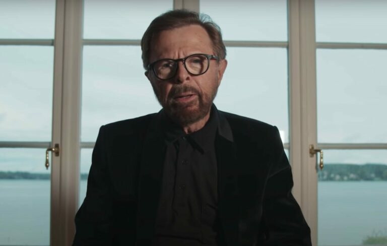 Björn Ulvaeus wears a black suit in an interview with Apple Music