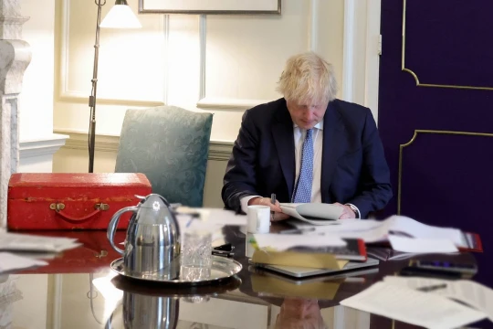 Downing Street has released a photo of Boris Johnson reading the report