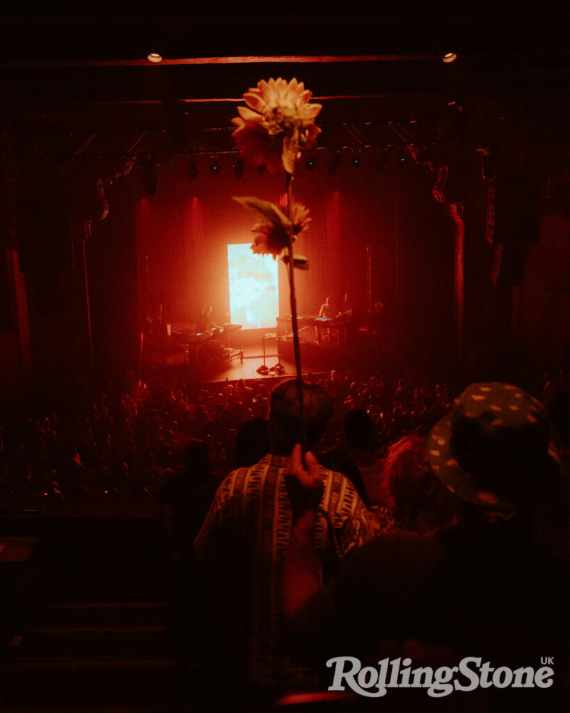 A fan brings a sunflower to Fred again..’s show at The Fonda Theatre, Los Angeles